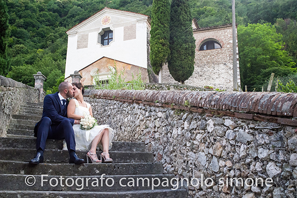 Fotografo matrimoni Rosà, fotografia matrimonio Bassano del grappa, servizio fotografico matrimoniale a Rosà e Bassano del Grappa,, fotografo sposi Rosà e Bassano del grappa, foto in orizzontale degli sposi seduti sui gradini della chiesa di Bassano del Grappa